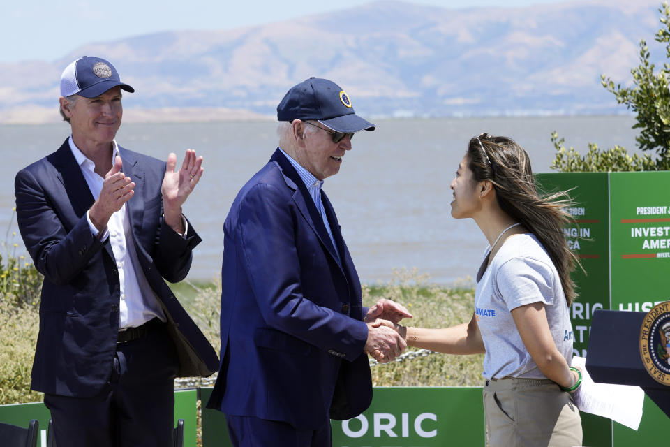 President Joe Biden shakes hands with Chiena Ty, an environmental student, after he was introduced to speak at the Lucy Evans Baylands Nature Interpretive Center and Preserve in Palo Alto, Calif., Monday, June 19, 2023. California Gov. Gavin Newsom applauds at left. (AP Photo/Susan Walsh)