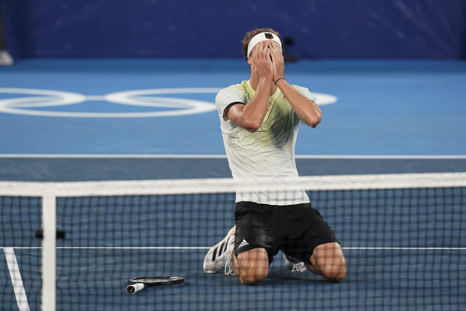 Alexander Zverev, of Germany, reacts after winning the men's single gold medal match of the tennis competition against Karen Khachanov, of the Russian Olympic Committee, at the 2020 Summer Olympics, Sunday, Aug. 1, 2021, in Tokyo, Japan. (AP Photo/Patrick Semansky)