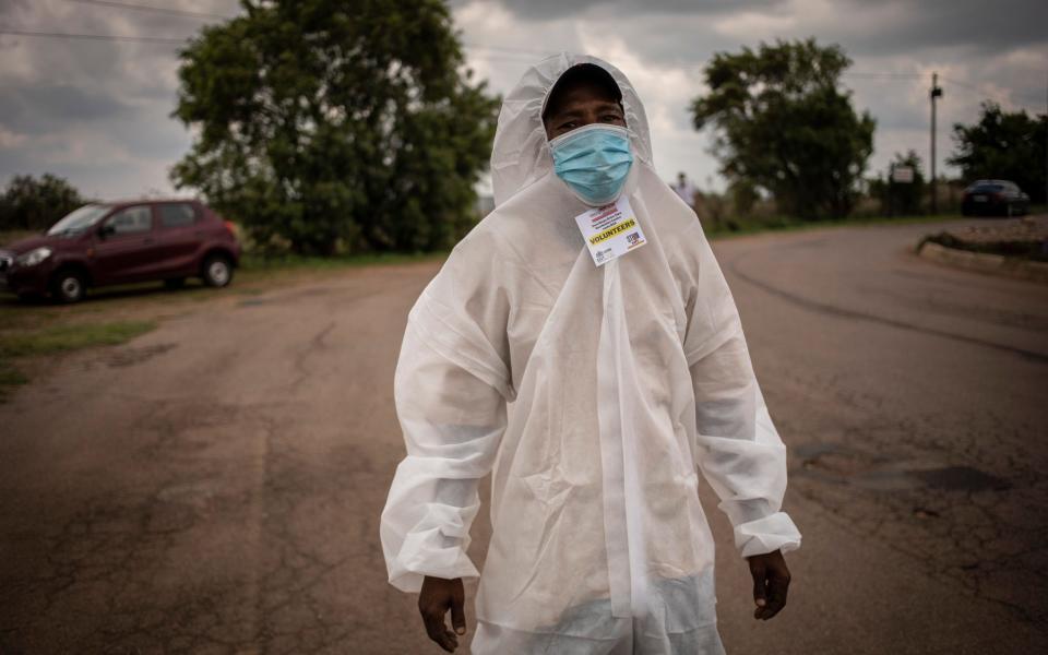 A volunteer wears personal protective equipment (PPE) at a Covid-19 drive-through vaccination facility at the Zwartkops Raceway in Pretoria, South Africa, 15 December 2021 - Kim Ludbrook/EPA-EFE/Shutterstock