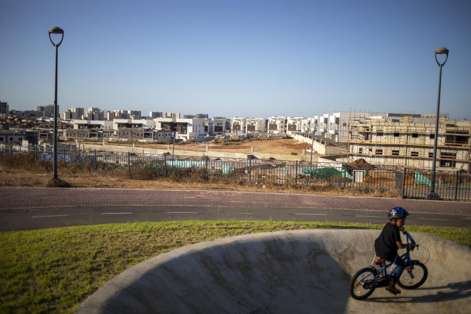 A boy rides his bicycles in a public park in Sderot, Israel, Wednesday, July 21, 2021. No place in Israel has been hit harder by Palestinian rocket fire than Sderot, a working-class town just about a mile (1.5 kilometers) from the Gaza border. Although Sderot is enjoying an economic boom and revival, a generation of children and parents are suffering from the traumatic effects of two decades of rocket fire that experts are still struggling to understand.