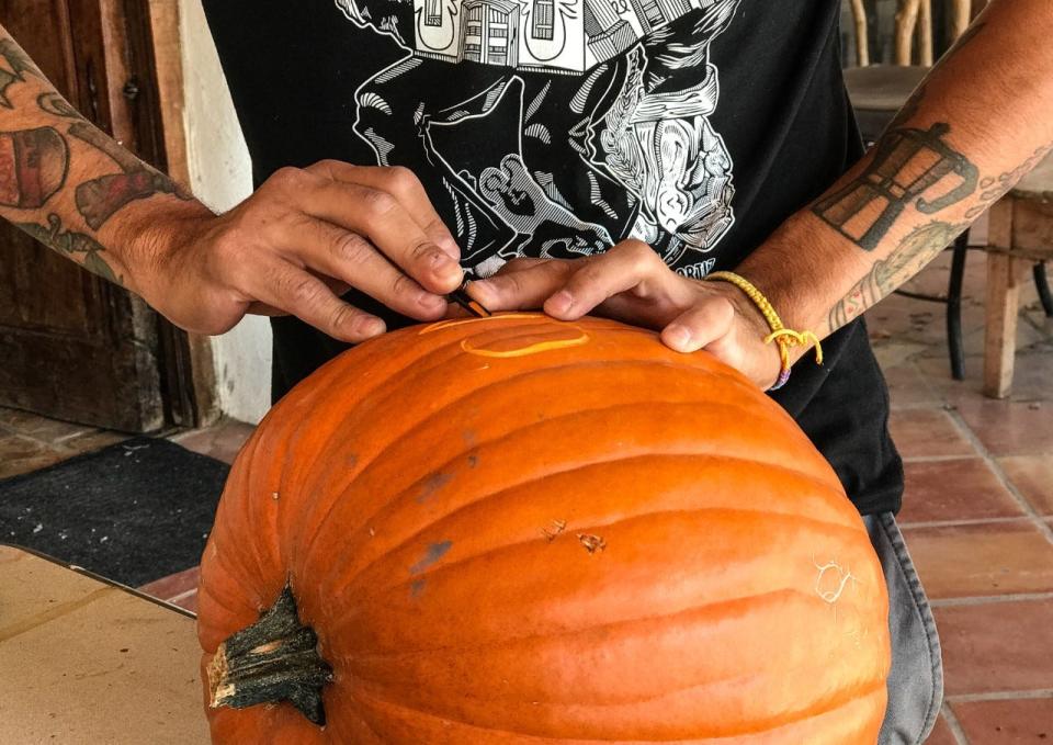 Artist Mario Alonso Perez uses his carving skills on a pumpkin in October.