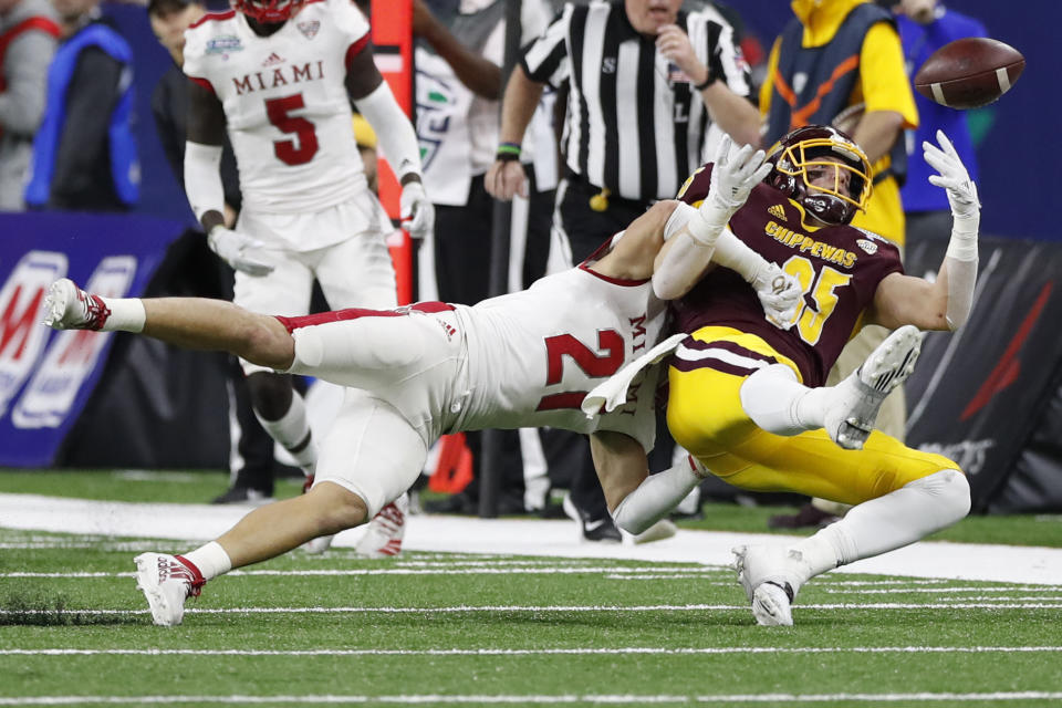 Miami of Ohio defensive back Sterling Weatherford (21) breaks up a pass intended for Central Michigan tight end Tony Poljan (85) during the first half of the Mid-American Conference championship NCAA college football game, Saturday, Dec. 7, 2019, in Detroit. (AP Photo/Carlos Osorio)