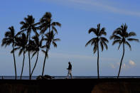 Hideki Matsuyama, of Japan, walks across the 17th green during the second round of the Sony Open golf tournament, Friday, Jan. 14, 2022, at Waialae Country Club in Honolulu. (AP Photo/Matt York)