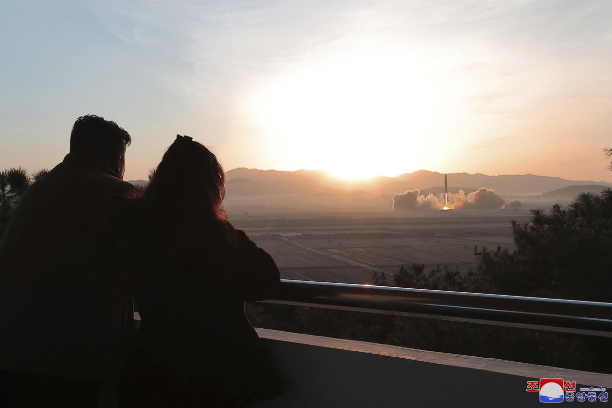 In this photo provided by the North Korean government, North Korean leader Kim Jong Un, left, watches what it says is a test launch of an intercontinental ballistic missile, with a young woman who appears to look like his daughter, at the Sunan international airport in Pyongyang, North Korea, Thursday, March 16, 2023. (Korean Central News Agency/Korea News Service via AP)