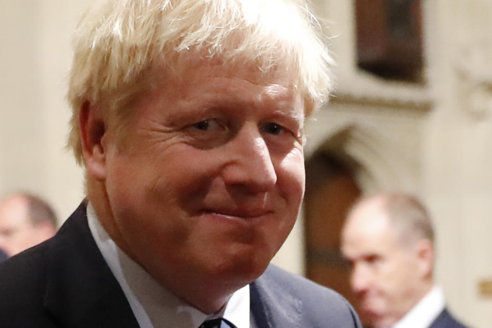 Prime Minister Boris Johnson walks back through the Peers Lobby after the State Opening of Parliament by Queen Elizabeth II, in the House of Lords at the Palace of Westminster in London.