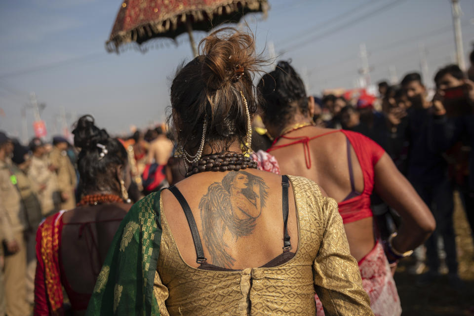 In this Jan. 15, 2019, photo, Indian hijras of the "Kinnar akhara" monastic order leave the river bank after taking a dip on the auspicious Makar Sankranti day during the Kumbh Mela festival in Prayagraj, Uttar Pradesh state, India. Unlike other akharas, which are only open to Hindu men, Kinnar, founded in 2015, is open to all genders and religions. Hinduism’s ancient Vedas scriptures describe transgender people, or hijras, as holding an integral space in society. (AP Photo/Bernat Armangue)