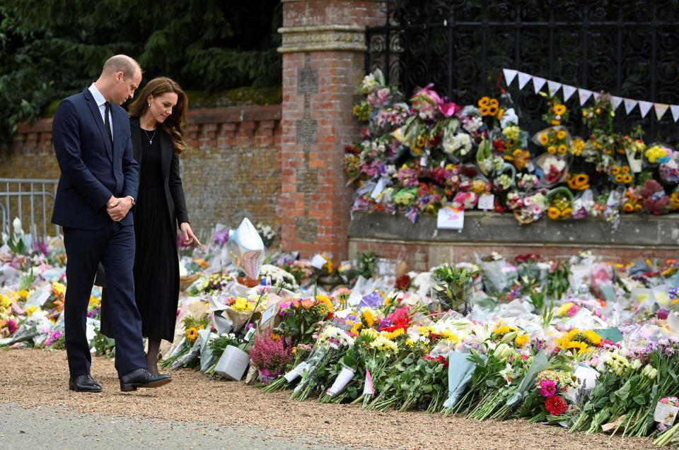 Prince William, Prince of Wales and Britain's Catherine, Princess of Wales view floral tributes outside Norwich Gate on the Sandringham Estate in Sandringham, eastern England, on September 15, 2022, following the death of Queen Elizabeth II.