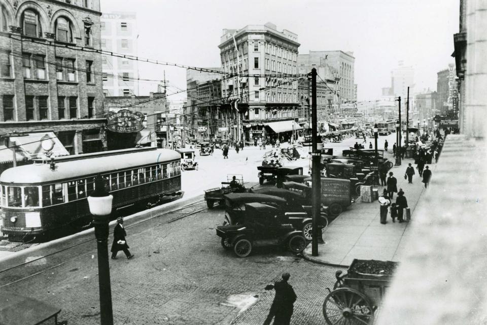 Downtown Akron is a blur of activity in 1920. This was the view looking north on South Main Street near South Howard Street. The landmark at the center is the Flatiron Building, now the site of Cascade Plaza.