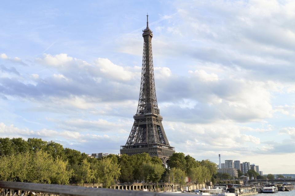 side view of the eiffel tower from a bridge over the seine river without people with a sunset in paris