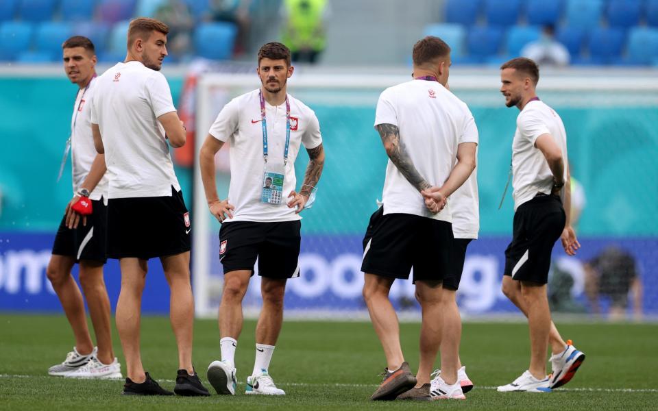 Poland players inspect the pitch before kick off - GETTY IMAGES