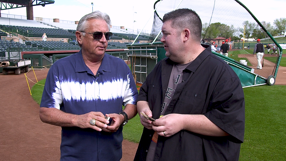 Giants broadcaster Duane Kuiper looks through 1983 Fleer and 1987 Topps baseball cards. (Yahoo Sports)