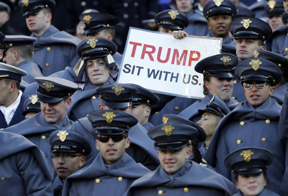 FILE - In this Saturday, Dec. 8, 2018, file photo, an Army cadet displays a sign for then President-elect Donald Trump in the first half of the Army-Navy NCAA college football game in Baltimore. President Trump will attend the Army-Navy football game, Saturday, Dec. 8, 2018, in Philadelphia. (AP Photo/Patrick Semansky, File)