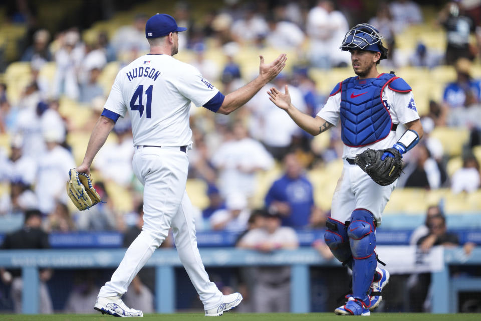 Los Angeles Dodgers relief pitcher Daniel Hudson (41) celebrates with catcher Austin Barnes after a 4-0 win over the Colorado Rockies in a baseball game in Los Angeles, Sunday, June 2, 2024. (AP Photo/Ashley Landis)