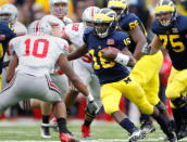 Denard Robinson #16 of the Michigan Wolverines tries to get around the tackle of Ryan Shazier #10 of the Ohio State Buckeyes at Michigan Stadium on November 26, 2011 in Ann Arbor, Michigan. Michigan won the game 40-34. (Photo by Gregory Shamus/Getty Images)