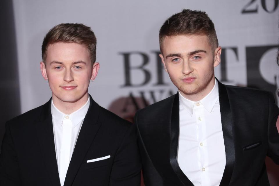 Howard Lawrence, left, and his brother Guy of British electronic music duo Disclosure arrive at the BRIT Awards 2014 at the O2 Arena in London on Wednesday, Feb. 19, 2014. (Photo by Joel Ryan/Invision/AP)