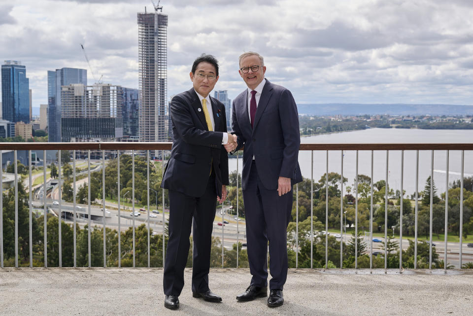 Japan's Prime Minister Fumio Kishida, left, shakes hands with Australian Prime Minister Anthony Albanese in Perth, Australia, Saturday, Oct. 22, 2022. Kishida is on a visit is to bolster military and energy cooperation between Australia and Japan amid their shared concerns about China. (Stefan Gosatti/Pool Photo via AP)