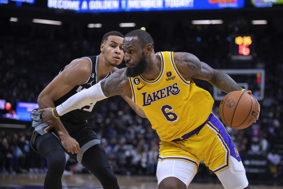 Los Angeles Lakers forward LeBron James (6) drives past Sacramento Kings forward Keegan Murray (13) during the second half in an NBA basketball game in Sacramento, Calif., Wednesday, Dec. 21, 2022. The Kings won 134-120. (AP Photo/José Luis Villegas)