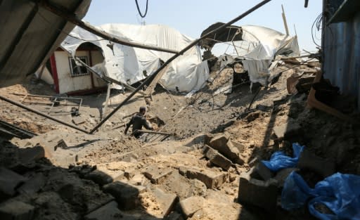 A man inspects the damage at a site targeted by an Israeli air strike in the southern Gaza strip