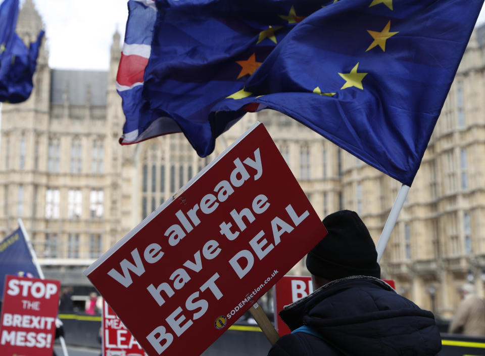 Anti Brexit and pro European Union protesters carry flags and placards as they demonstrate outside the Palace of Westminster in London, Monday, March 11, 2019. British Prime Minister Theresa May still hopes to secure changes from the EU that can win U.K. lawmakers' backing for her Brexit deal, despite a lack of progress in last-minute talks. (AP Photo/Alastair Grant)