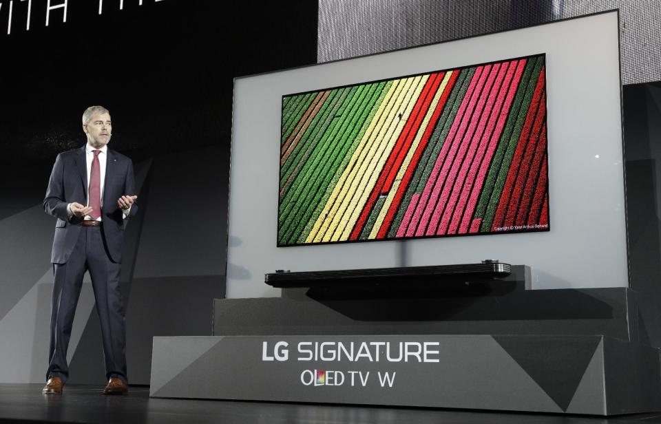 David VanderWaal, vice president of marketing for LG Electronics USA, unveils the LG Signature OLED TV W during an LG news conference before CES International, Wednesday, Jan. 4, 2017, in Las Vegas. (AP Photo/John Locher)