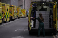 FILE - A paramedic opens the doors of an ambulance to take a patient into the Royal London Hospital in the Whitechapel area of east London, Jan. 6, 2022. The omicron variant is exposing weaknesses at the heart of Europe's public health system. In France and Britain, a sharp rise in coronavirus hospitalizations coupled with staff falling sick has led to a shortage of beds. (AP Photo/Matt Dunham, File)