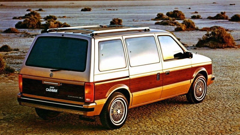 A photo of a Dodge Caravan minivan on a beach. 