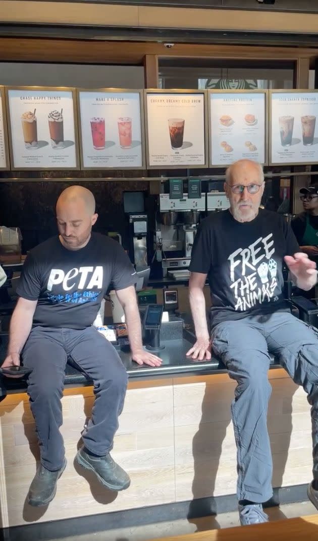 James Cromwell and another PETA activist superglued their hands to the counter of a Starbucks in Manhattan. (Photo: PETA/Facebook)