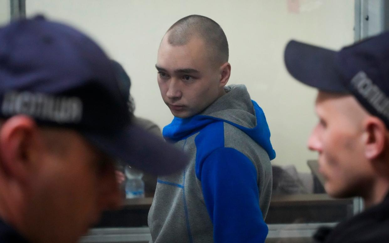 Russian army Sergeant Vadim Shishimarin, 21, is seen behind a glass during a court hearing in Kyiv