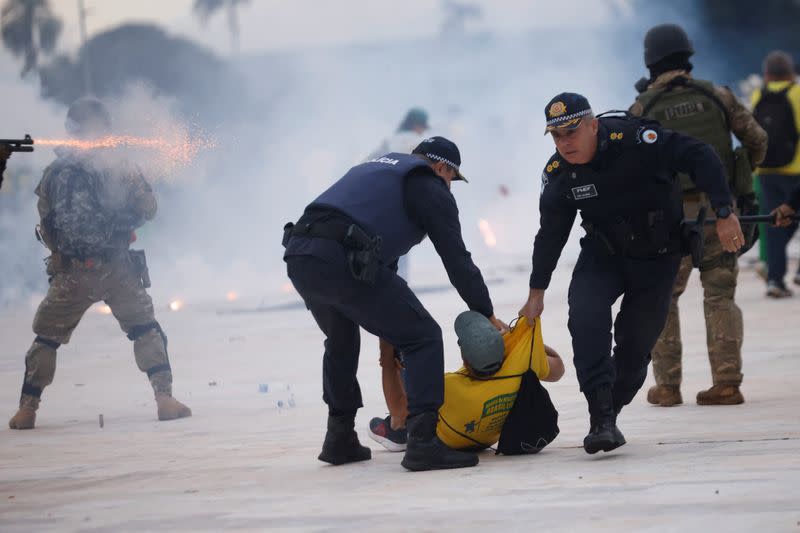 Colonel Naime detains a supporter of Bolsonaro during a demonstration against President Lula in Brasilia