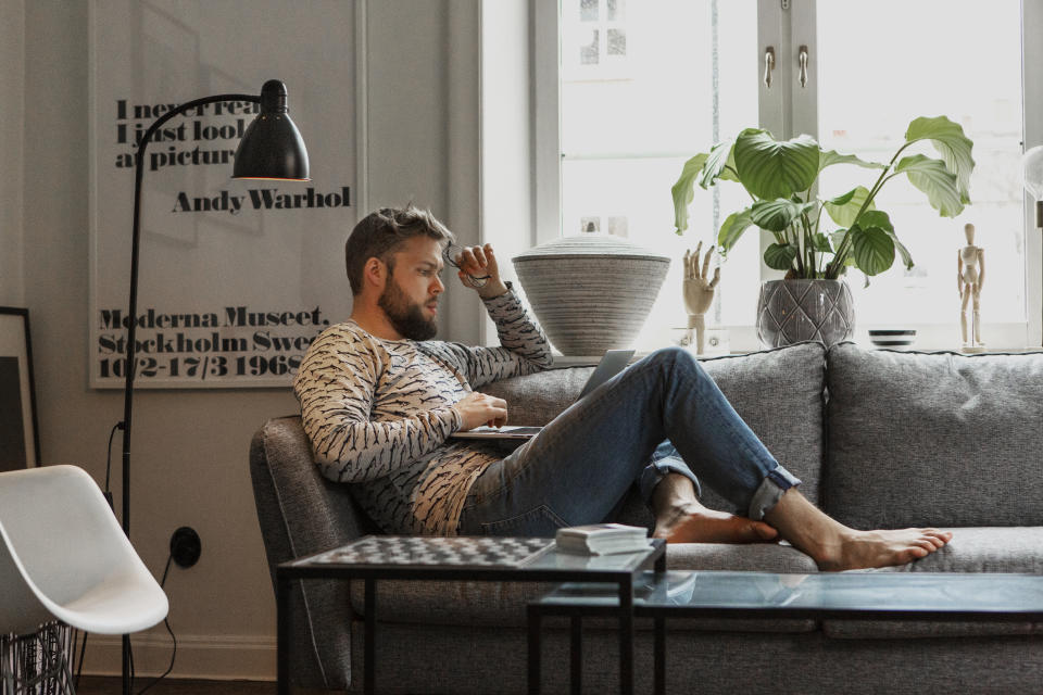 Man on sofa using laptop