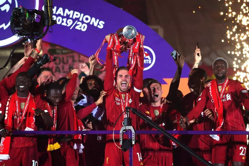 Jordan Henderson lifts the Premier League trophy ending the 30-year wait