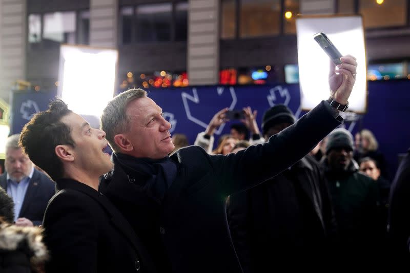 Actors Daniel Craig and Rami Malek pose for a selfie during a promotional appearance on TV in Times Square for the new James Bond movie "No Time to Die" in the Manhattan borough of New York City
