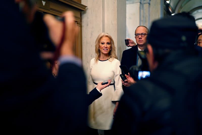 White House senior adviser Kellyanne Conway is followed by reporters in Washington