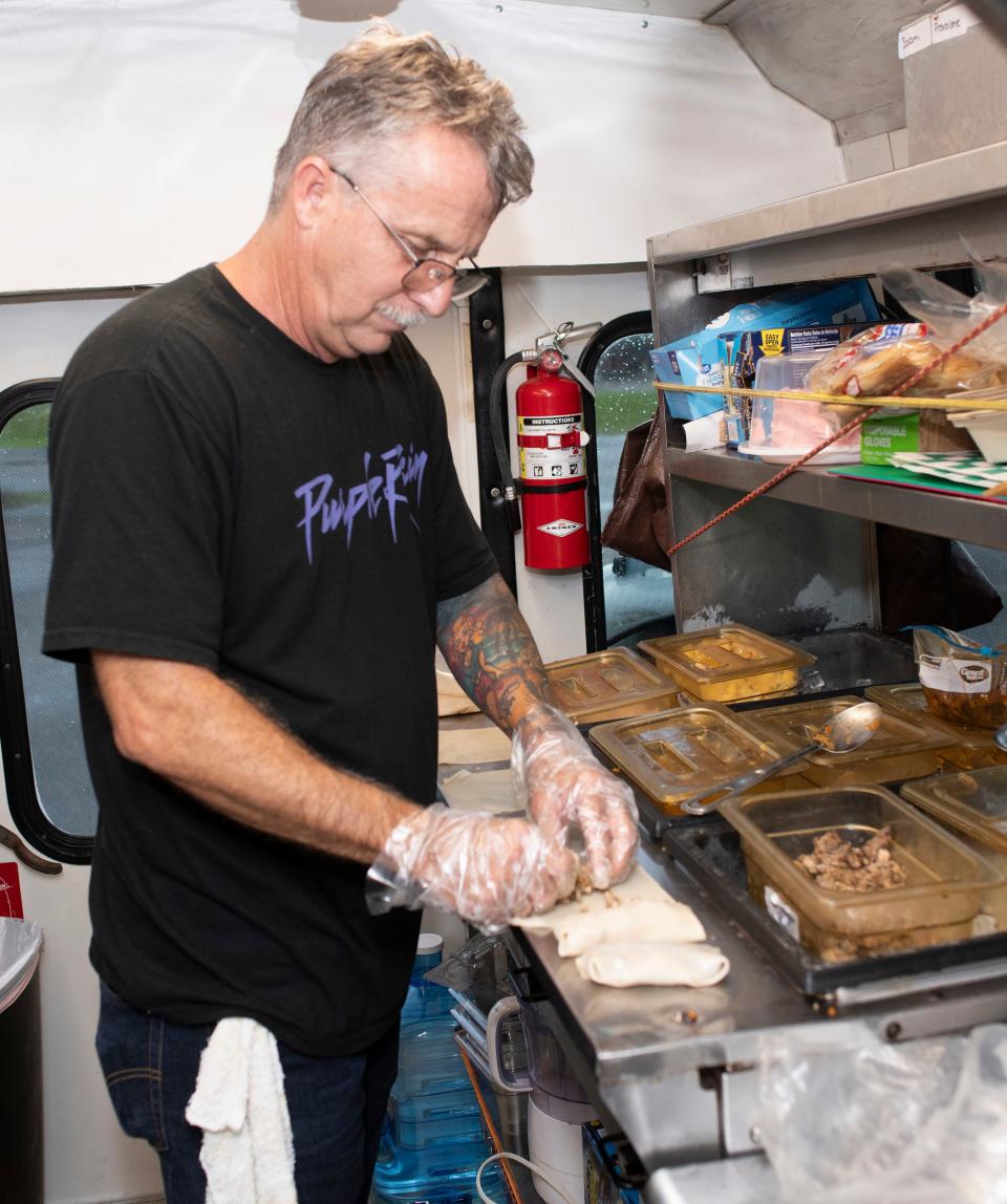 Frank Humphreys works on a creation Tuesday at the P'Cola Rolla food truck.
