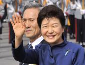 South Korean President Park Geun-Hye waves as she inspects troops with Defence Minister Kim Kwan-Jin (L) during a ceremony marking the 65th anniversary of the founding of South Korea's Armed Forces at an air base in Seongnam, south of Seoul October 1, 2013. (REUTERS/Jung Yeon-je)