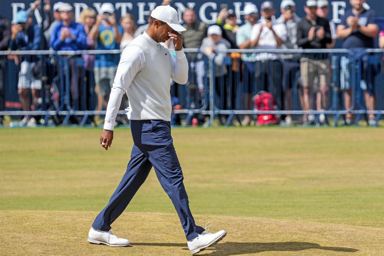 Tiger Woods wipes tears from his eyes as he walks up the 18th fairway in an emotional end to his 2nd round. Woods will miss the cut and won't play in Saturday &amp; Sunday's rounds. The British Open Championship, Day Two, Golf, St Andrews, Fife, UK - 15 Jul 2022