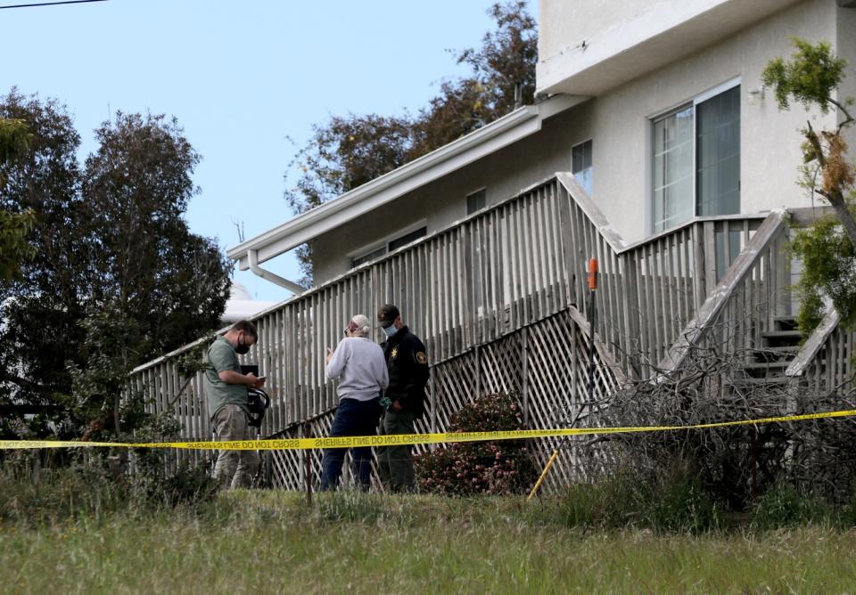 Sheriff's deputies search a property.