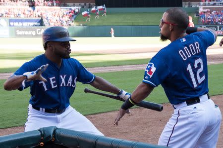 Oct 4, 2015; Arlington, TX, USA; Texas Rangers center fielder Delino DeShields (7) celebrates with second baseman Rougned Odor (12) after scoring a run against the Los Angeles Angels during the seventh inning at Globe Life Park in Arlington. The Rangers won 9-2 and clinch the American League West division. Mandatory Credit: Jerome Miron-USA TODAY Sports