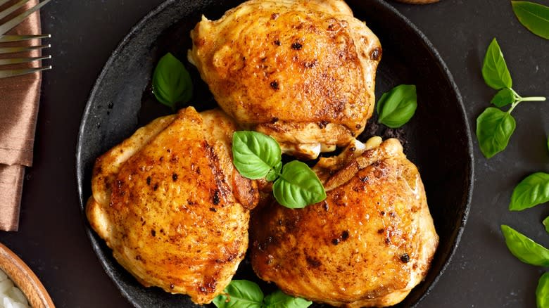 Top-down view of crispy chicken thighs in a pan