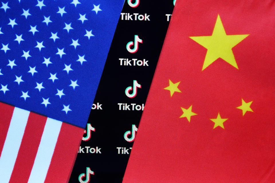 CHINA - 2020/08/05: In this photo illustration, a TikTok logo is seen displayed on a smartphone with a Chinese American flag in the background. (Photo Illustration by Sheldon Cooper/SOPA Images/LightRocket via Getty Images)