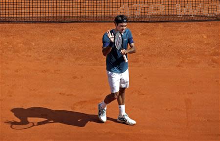 Roger Federer of Switzerland reacts after defeating Lukas Rosol of the Czech Republic during the Monte Carlo Masters in Monaco April 17, 2014. REUTERS/Eric Gaillard