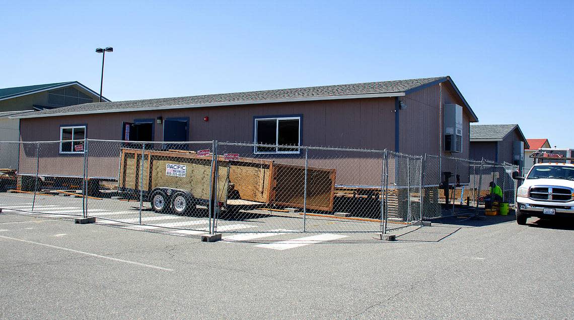 Pasco School District contractors work Wednesday, Aug. 3 on the foundation of a portable that will be installed at Chiawana High School. The school is installing six new portables before students return this fall.