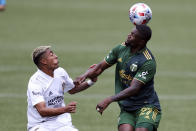 Portland Timbers midfielder Dairon Asprilla (27) heads the ball next to LA Galaxy defender Julian Araujo (2) during the first half of an MLS soccer match, Saturday, May 22, 2021, in Portland, Ore. (AP Photo/Amanda Loman)