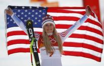 Alpine Skiing - Pyeongchang 2018 Winter Olympics - Women's Downhill - Jeongseon Alpine Centre - Pyeongchang, South Korea - February 21, 2018 - Bronze medallist Lindsey Vonn of the U.S. celebrates with the Italian flag during the flower ceremony. REUTERS/Leonhard Foeger