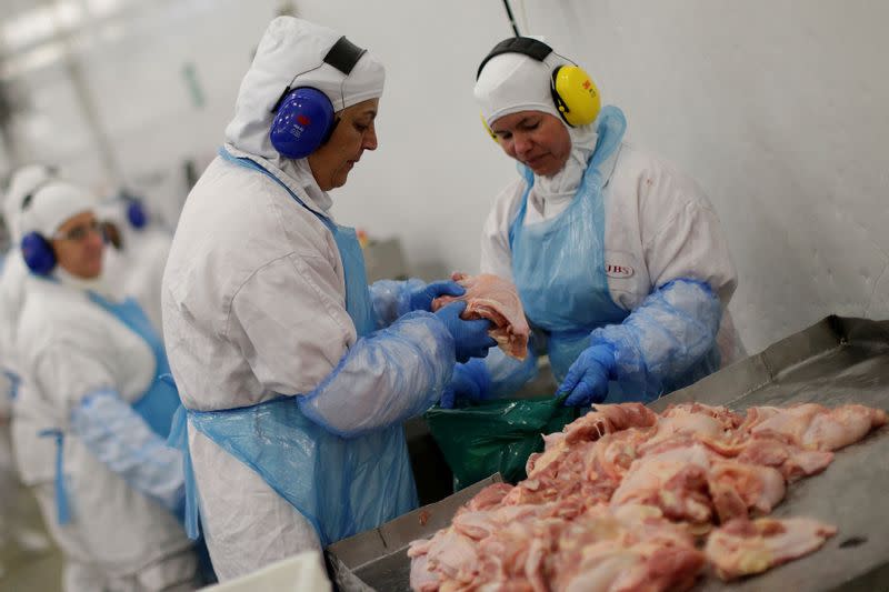 FILE PHOTO: Employees are seen during a technical visit of Brazil's Agriculture Minister Blairo Maggi at the Brazilian meatpacker JBS SA in the city of Lapa