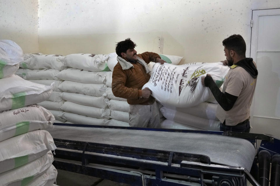 FILE - Workers load bags of flour into a truck at the Big Mills factory in the southern town of Sebline, south of Beirut, Lebanon, March 15, 2022. Russia’s war in Ukraine has threatened food supplies in countries like Lebanon, which has the world's highest rate of food inflation, 122%, and depends on the Black Sea region for nearly all of its wheat. The Razoni, loaded up with 26,000 tons of corn, is the first cargo ship to leave Ukraine since the Russian invasion, and set sail from Odesa Monday, August 1, 2022. Its final destination is Lebanon, with estimated arrival date on Saturday, Aug. 6, 2022. (AP Photo/Bilal Hussein, File)