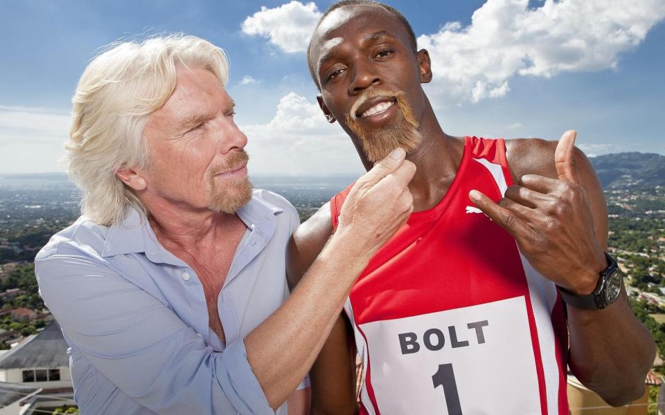 Usain Bolt appears with Richard Branson in an campaign for Virgin Media - PA