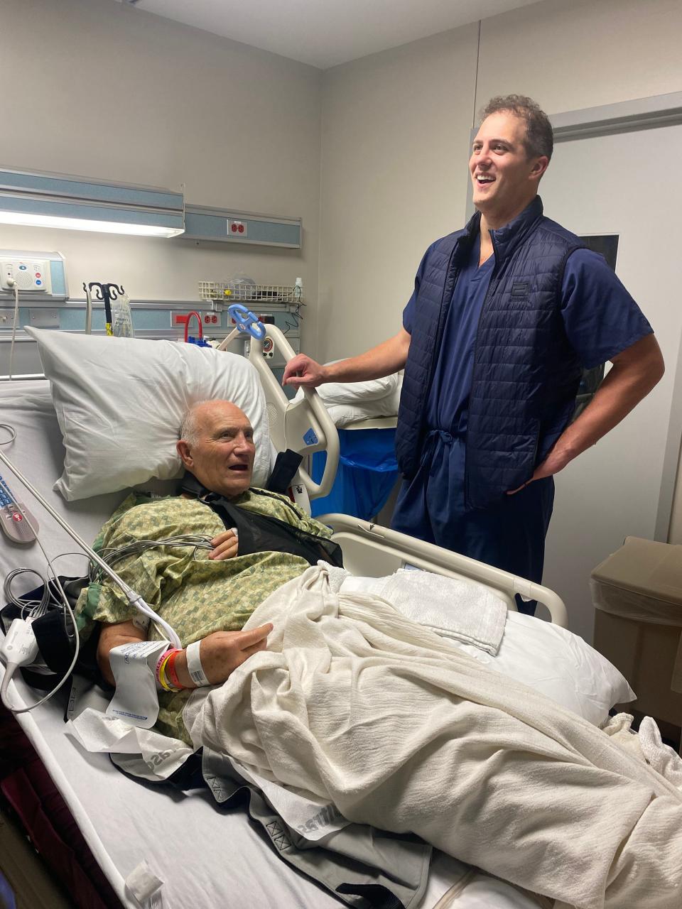 Matt Nader visits with Bill Wolters at North Austin Medical Center on Wednesday. Wolters had an AED implanted in his chest. Nader helped save his life when he was stricken after a football game Dec. 9.