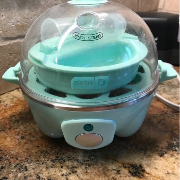 Reviewer's photo of blue egg cooker on a kitchen counter.