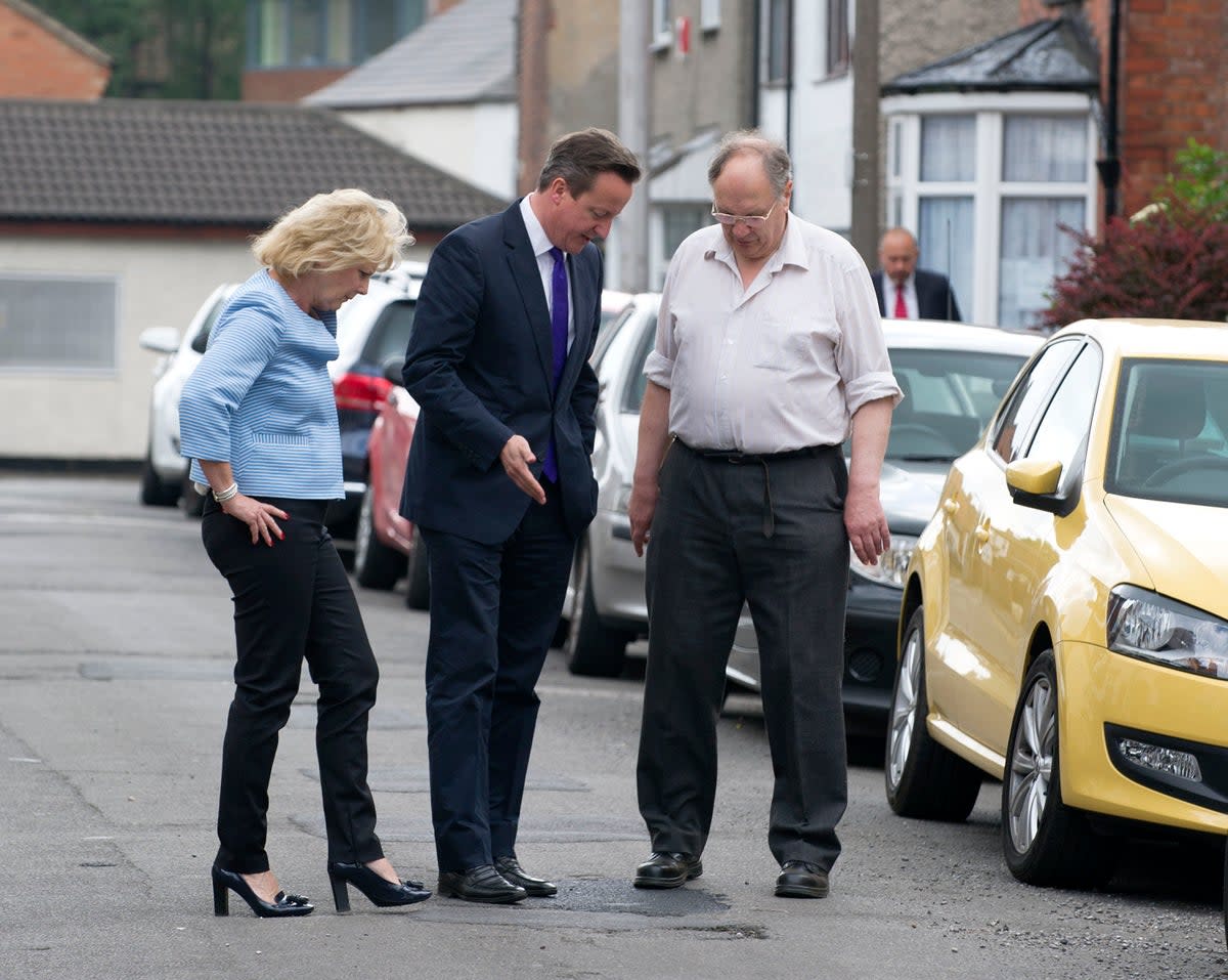 Pointing at potholes is a job not even prime ministers are above, as David Cameron proved in 2014 (PA)